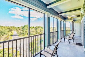 Private Screened-In Balcony Offering Scenic Views And Comfortable Seating