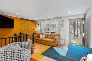 Modern living room with smart TV and tons of sunlight!