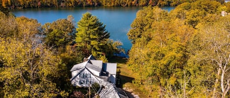 Charming lakeside retreat nestled in vibrant fall foliage—your serene getaway awaits!