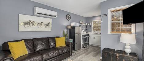 Open living area with queen sleeper sofa and Smart TV