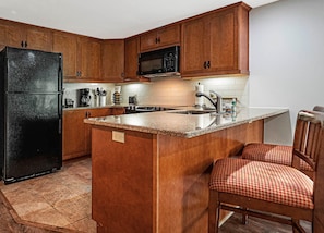 Full kitchen with a full size fridge