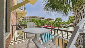 Balcony with table and seats overlooking resort amenities