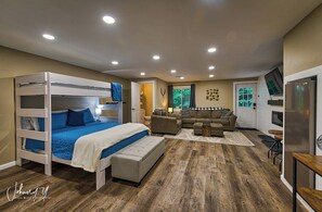The lower level is bright and ready to entertain with multiple overhead can lights, a large window and the exterior door that exits to the grill and driveway.