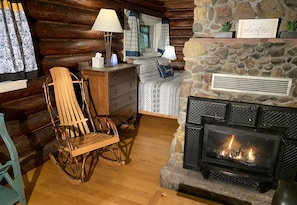 Log Cabin Living with Bedroom Behind Fireplace