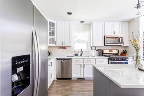 Fully stocked kitchen with utensils and cookware to prepare your favorite meal.