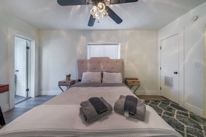 Bedroom with queen-size bed, en-suite bathroom, and closet