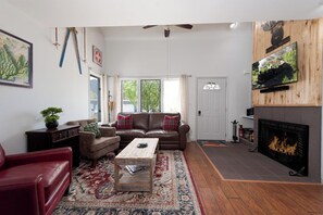 Main Living Space - TV and wood burning fireplace