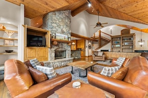 Living Room with balcony, gas fireplace, and flatscreen TV.