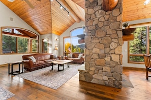 LLiving Room with balcony, gas fireplace, and flatscreen TV.