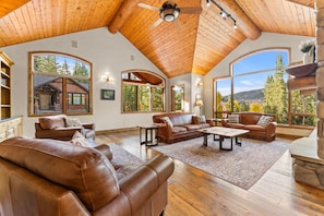 Living Room with balcony, gas fireplace, and flatscreen TV.