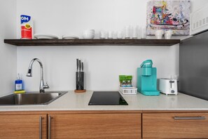 Discover culinary convenience in this well-organized kitchen space with a clean, spacious countertop and modern stainless steel sink.