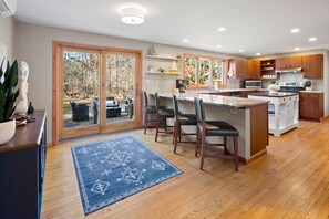 Barstools on the peninsula and large slider to the back patio