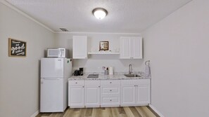 Open Concept Kitchen Area:Refrigerator, stove, microwave, & lot a more amenities