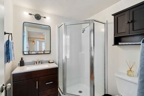 Private bathroom with essentials such as soap, shampoo, conditioner, body wash, makeup wipes & towel