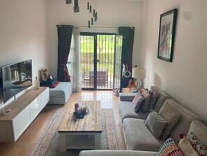 Split level lounge area, with French doors to patio/garden and golf course 