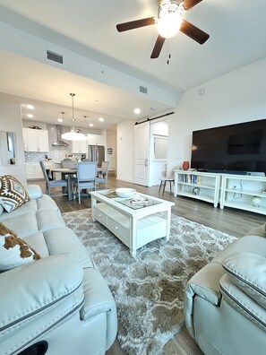 Open concept living room,comfy reclining couches. Smart TV with surround system.