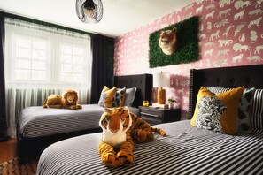 [Bedroom 3- Jungle] Experience the vibrant Tiger-themed Jungle Kids Room upstairs—a playful space designed to spark adventure. With lively animal prints and jungle accents, it features two cozy twin beds for a thrilling night's sleep.