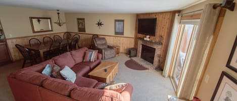 Our comfy living room has views of Mt. Snow and a wood burning fireplace.