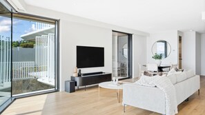 Bright and airy lounge area with sofa and TV