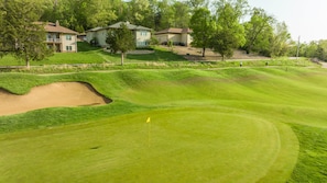 View of the house from the golf course. All three houses shown are available.