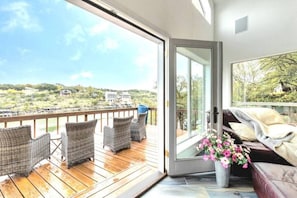 Living area easily opens to the outside to enjoy the lake