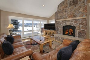 Main level living room with smart TV and gas fireplace.