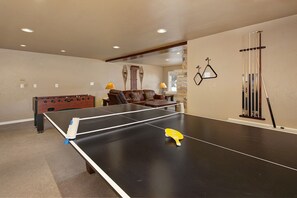 The game area has a pool table, foosball and ping pong table. Also, there is a wet bar for snacks and drinks with sink area, full size refrigerator, microwave, and dishwasher.