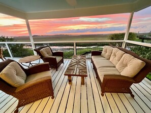 covered back porch with stunning marsh views & nightly sunsets.