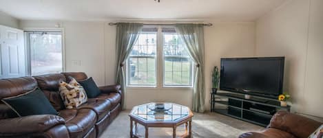 Welcome to The Hideaway @ Prestwood Farms! Cozy living room with a nice view of the nature outside.