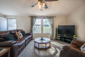 Welcome to The Hideaway @ Prestwood Farms! Cozy living room with a nice view of the nature outside.