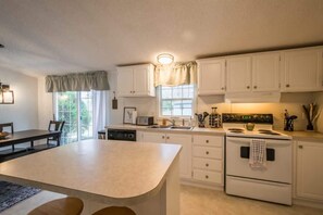 Well lighted kitchen and dining table for your convenience.