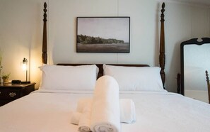 Cozy and clean white Queen sized bed to rest and sleep.