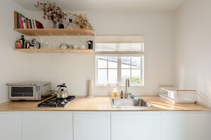 Kitchenette with integrated refrigerator.