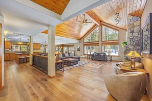 Expansive Great Room with Timber Ceilings and Stone Fireplace