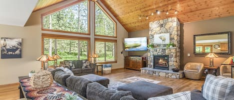Massive Picture Windows look out on Towering Pines from the Great Room