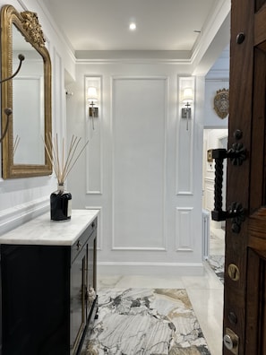 Front entry view from the hallway through the main apartment door.