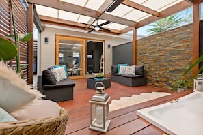 Outdoor seating area, ceiling fan, heated spa bath.