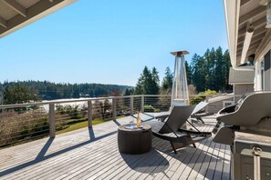 The large deck offers multiple areas to relax, dine, and gather.