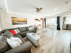 Rustic wood accent wall provides a beachy feel.