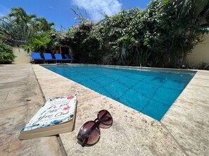 Swimming pool with loungers