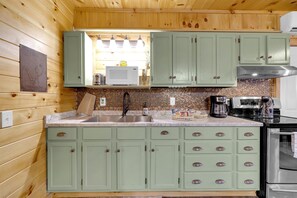 Fully equipped kitchen with a unique penny backsplash.