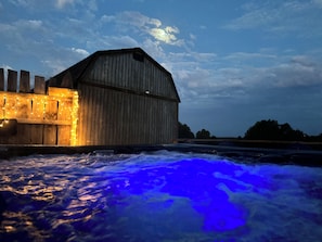 Hot tub with the full moon behind it in the morning