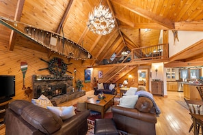 Large ADK style living room with plenty of comfortable seating and cozy blankets
