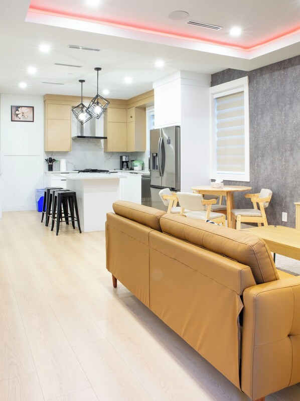 Modern Furnished living room and kitchen with island