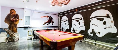 Star Wars themed game room with full size pool table and air hockey table
