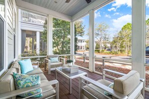 Screened-in front porch with comfy seating
