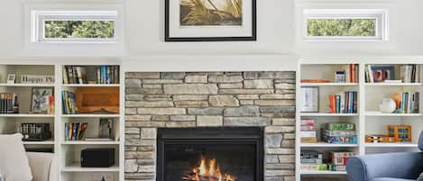 The Cottage has a cozy and inviting living room with stone fireplace.