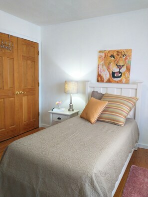 Twin bed in this sweet sunny room.