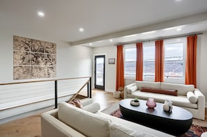 Stairs from the basement leading up into the main living room and dining area.