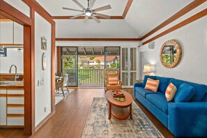 Air conditioner, a dining table for four, and a Queen-sized pull-out sofa bed.